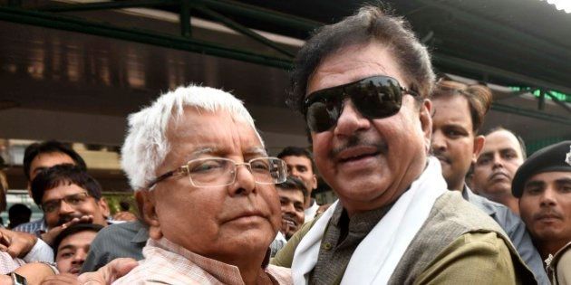 PATNA, INDIA - NOVEMBER 9: BJP leader Shatrughan Sinha hugs the RJD Chief Lalu Prasad Yadav after landslide victory of the grand alliance in Bihar Assembly Elections on November 9, 2015 in Patna, India. The newly-formed JD(U)-RJD-Congress alliance defeated Narendra Modi led NDA alliance by securing 178 seats in the 243-member House. RJD emerged the leader of the pack with 80 seats while JD(U) bagged 71 in the recently-concluded Bihar polls. (Photo by Arun Sharma/Hindustan Times via Getty Images)