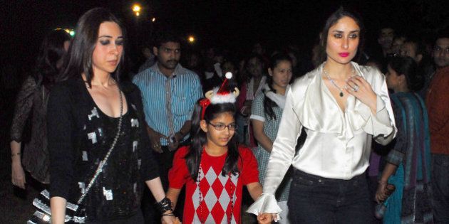 MUMBAI, INDIA - DECEMBER 24: Indian bollywood actresses Kareena Kapoor and Karisma Kapoor with her daughter came out to St. Andrews Church in Bandra for Christmas celebrations on December 24, 2012 in Mumbai, India. (Photo by Prodip Guha/Hindustan Times via Getty Images)