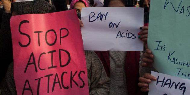 SRINAGAR, KASHMIR, INDIA - DECEMBER 12: A Kashmir law students hold a placards during a protest against acid attack on December 12, 2014 in Srinagar, the summer capital of Indian administered Kashmir, India. Dozens of Kashmiri law students held a protest in the Muslim majority state of Kashmir demanding immediate arrest and stringent punishment to the acid attackers involved in yesterday's acid attack on a law student that left her in a critical condition. A 21-year-old Law student was injured Thursday in an acid attack by unidentified car-borne youth outside her college in Srinaga the summer capital, police said. (Photo by Yawar Nazir/Getty Images)