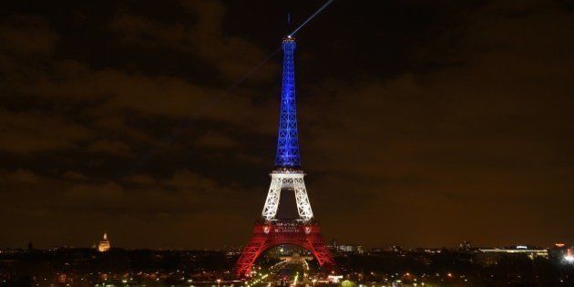 A photo taken on November 16, 2015 in Paris shows the Eiffel Tower illuminated with the colours of the French national flag in tribute to the victims of November 13 Paris terror attacks which killed at least 129 people in scenes of carnage at a concert hall, restaurants and the national stadium. AFP PHOTO / ERIC FEFERBERG (Photo credit should read ERIC FEFERBERG/AFP/Getty Images)