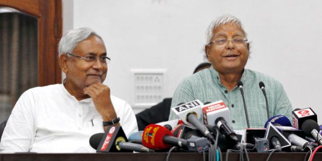 PATNA, INDIA - NOVEMBER 8: Janata Dal-United (JD-U) leader Nitish Kumar and Rashtriya Janta Dal leader Lalu Prasad Yadav during a press conference after landslide victory in Bihar Assembly elections at Nitish Kumar's residence, on November 8, 2015 in Patna, India. Nitish Kumar said, 'I express my gratitude towards people of Bihar, will try our best to match up with their expectations. We respect our opposition in Bihar; want to work in consensus with everyone to develop Bihar. This victory is big win and we will work towards the grand alliances mandate for the development of Bihar.' Lalu Yadav said, 'BJP had its eyes on Kolkata, the capital of West Bengal. It wanted to move eastwards. Bihar stopped them in tracks. PM Narendra Modi is nothing but an RSS pracharak.' The grand alliances victory is also attributed to the rejection of communal politics, driven mostly by the recent debate over cow slaughter and consumption of beef. Data from the election commissionâs website for 240 of the stateâs 243 seats showed the RJD-JD(U)-Congress alliance led in 178 seats, an emphatic victory over the NDA that could only win around 59 seats. (Photo by Ajay Aggarwal/Hindustan Times via Getty Images)