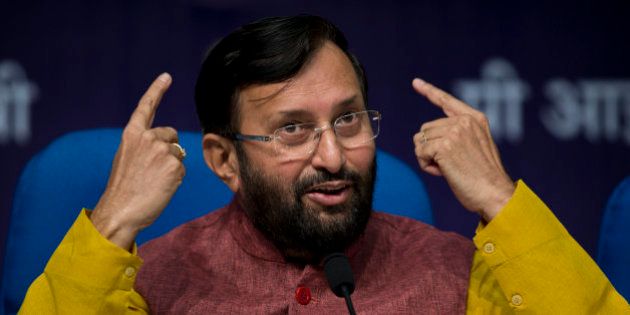 Indian Environment Minister, Prakash Javadekar, addresses journalists at a press conference to elaborate upon India's submission for a global climate pact to cut down on the intensity of its carbon emissions, in New Delhi, India, Friday, Oct. 2, 2015. India has pledged to slash the rate of emissions relative to gross domestic product by 33-35 percent by 2030 from 2005 levels. (AP Photo/Saurabh Das)