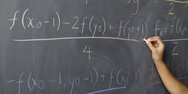 Woman writing Color Equations on Blackboard