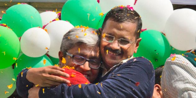 FILE - In this Tuesday, Feb. 10, 2015 file photo, Aam Aadmi Party, or Common Manâs Party leaders, Arvind Kejriwal, right, and Ashutosh, hug each other as they celebrate news of their party's performance in New Delhi, India. Kejriwal, the former tax official with the chronic cough and the ill-fitting sweaters, the man who had remade himself into a champion for clean government, seemed lost in the political wilderness. The crusading politician was suddenly a punchline. But on Wednesday, Feb. 11, there was Kejriwal on the front page of nearly every Indian newspaper, celebrating election results that again make him New Delhi's chief minister. Kejriwal and the party he created routed the country's best-funded and best-organized political machine and dealt an embarrassing blow to Prime Minister Narendra Modi. (AP Photo/Manish Swarup, File)