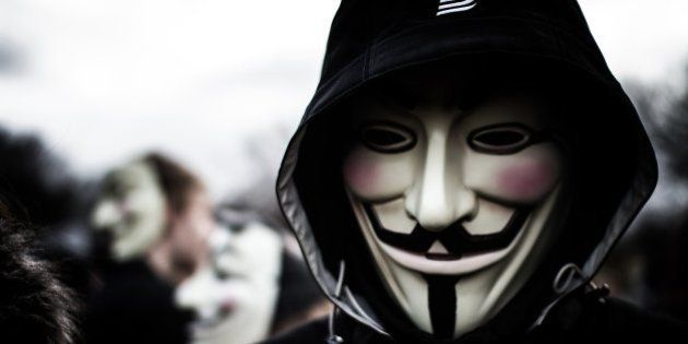 Person wears a Guy Fawkes mask which today is a trademark and symbol for the online hacktivist group Anonymous. 2012. (Photo by: PYMCA/UIG via Getty Images)