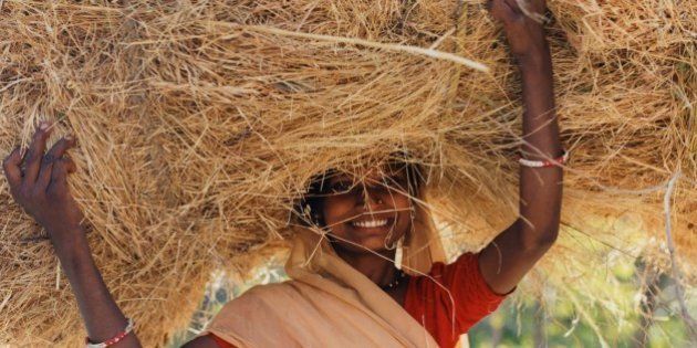 Woman carrying hay on her head