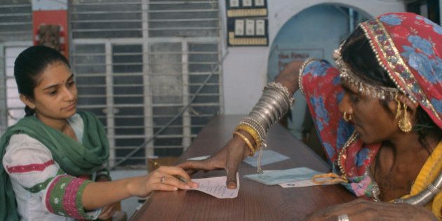 Rural Woman Putting A Thumb Impression In A Bank To Open Her Bank Account At Bank, Ahmedabad,India. (Photo by Education Images/UIG via Getty Images)