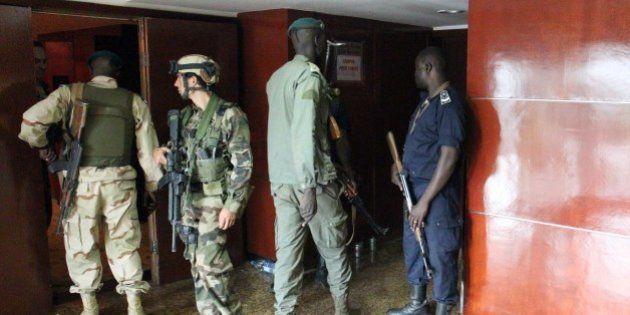 Malian soldiers and special forces stand guard at the entrance the Radisson Blu hotel in Bamako on November 20, 2015, after the assault of security forces. Malian forces backed by French troops stormed the Radisson Blu hotel in the capital Bamako after suspected Islamist gunmen seized guests and staff in a nine-hour hostage crisis that left at least 18 people dead. UN Secretary-General Ban Ki-moon condemned the 'horrific terrorist attack' on November 20, and indicated the violence was aimed at destroying peace efforts in the country. AFP PHOTO / HABIBOU KOUYATE (Photo credit should read HABIBOU KOUYATE/AFP/Getty Images)