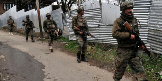 SRINAGAR, INDIA - APRIL 2: Army soldiers carry out a search operation for suspected militants during a gunbattle at Hardshoora village on April 2, 2015 some 35 kilometers (20 miles) north of Srinagar, India. Suspected terrorists killed two security personnel and wounded two soldiers and a civilian in a fierce gunbattle. (Photo by Waseem Andrabi/Hindustan Times via Getty Images)