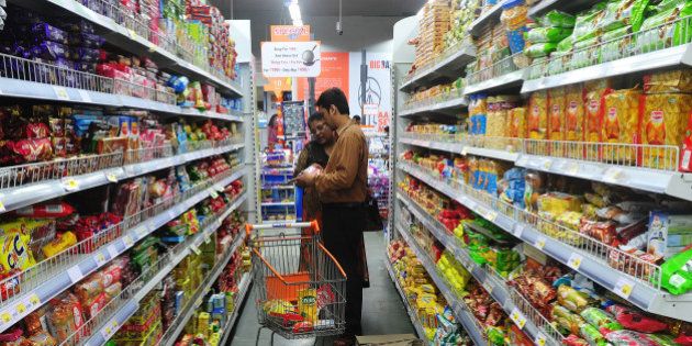 TO GO WITH: India-economy-retail-investment,update-FOCUSAn Indian family shops at the Big Bazaar supermarket in Mumbai on September 5, 2013. A year since India reduced foreign investment barriers to its retail sector to spur flagging economic growth, confusing rules and political uncertainty are keeping overseas supermarket giants away, analysts say. AFP PHOTO/ Indranil MUKHERJEE (Photo credit should read INDRANIL MUKHERJEE/AFP/Getty Images)
