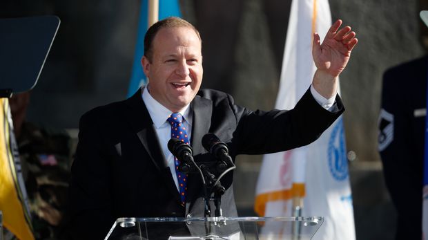 Colorado governor Jared Polis waves to the crowd after concluding his speech during the inauguration ceremony Tuesday, Jan. 8, 2019, in Denver. (AP Photo/David Zalubowski, Pool)