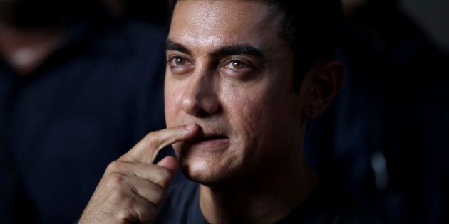 Bollywood actor Aamir Khan gestures during a media interaction on completion of his 25 years in Indian cinema, in Mumbai, India, Monday, April 29, 2013. (AP Photo/Rafiq Maqbool)