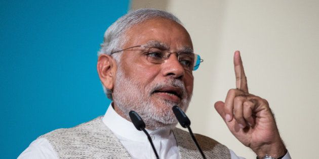 Narendra Modi, India's prime minister, gestures whilst speaking during the 37th Singapore Lecture held at the Shangri-La Hotel in Singapore, on Monday, Nov. 23, 2015. Modi's government, which in February pushed back its deadline for fiscal consolidation by a year to March 2018, faces a higher wage bill just as a sluggish economy and dwindling asset sales are weighing on revenue. Photographer: Nicky Loh/Bloomberg via Getty Images