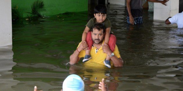 Indian rescuers carry a child to a truck as they evacuate people from a flooded residential area in Chennai on November 17, 2015. India has deployed the army and air force to rescue flood-hit residents in the southern state of Tamil Nadu, where at least 71 people have died in around a week of torrential rains. AFP PHOTO (Photo credit should read STR/AFP/Getty Images)