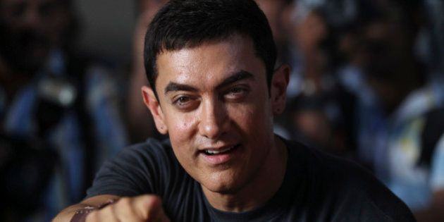 Bollywood actor Aamir Khan gestures during a media interaction on completion of his 25 years in Indian cinema, in Mumbai, India, Monday, April 29, 2013. (AP Photo/Rafiq Maqbool)