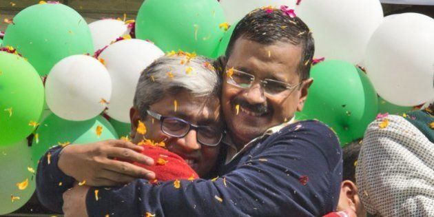 FILE - In this Tuesday, Feb. 10, 2015 file photo, Aam Aadmi Party, or Common Manâs Party leaders, Arvind Kejriwal, right, and Ashutosh, hug each other as they celebrate news of their party's performance in New Delhi, India. Kejriwal, the former tax official with the chronic cough and the ill-fitting sweaters, the man who had remade himself into a champion for clean government, seemed lost in the political wilderness. The crusading politician was suddenly a punchline. But on Wednesday, Feb. 11, there was Kejriwal on the front page of nearly every Indian newspaper, celebrating election results that again make him New Delhi's chief minister. Kejriwal and the party he created routed the country's best-funded and best-organized political machine and dealt an embarrassing blow to Prime Minister Narendra Modi. (AP Photo/Manish Swarup, File)