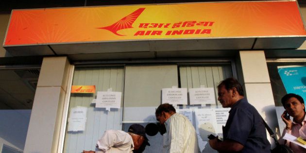 Indian passengers stand in a queue to make enquiries at an Air India counter at the airport in Ahmadabad, India, Friday, May 11, 2012. Hundreds of passengers have been stranded in India after Air India canceled around 20 international flights due to a strike by pilots. (AP Photo/Ajit Solanki)