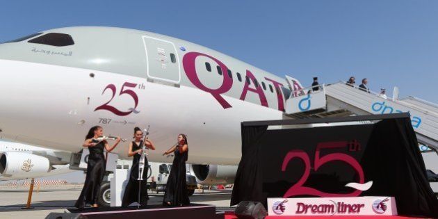 Musicians perform next to the 25th unit of Boeing 787 Dreamliner received by Qatar Airways and dislayed at the Dubai Airshow on November 9, 2015 in the Gulf Emirate. AFP PHOTO / MARWAN NAAMANI (Photo credit should read MARWAN NAAMANI/AFP/Getty Images)
