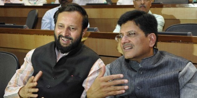 NEW DELHI, INDIA - JUNE 2: Prakash Javadekar, Minister of State for Information and Broadcasting (Independent Charge), Environment, Forest and Climate Change (Independent Charge) and Parliamentary Affairs, talking with Piyush Goyal, Minister of State (I/C) of Power, Coal & New & Renewable Energy during a conclave Sampark, Samanvya avam Samvad (Connect, Coordinate and Communicate) being organized for the officers of Ministries of Power, Coal and New & Renewable Energy, at Convention Hall, NDMC, Parliament Street, on June 2, 2014 in New Delhi, India. (Photo By Sonu Mehta/Hindustan Times via Getty Images)