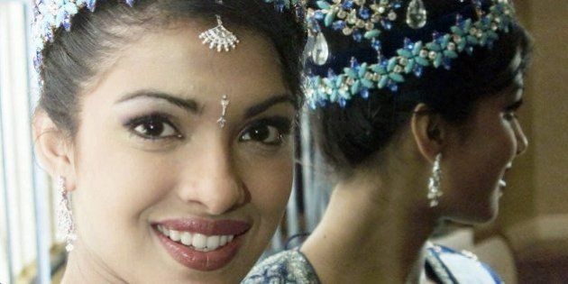 The new Miss World, India's Priyanka Chopra, 18, is reflected in a mirror during a photo session in London Friday, December 1, 2000, the morning after after she won her title.(AP Photo/Max Nash)