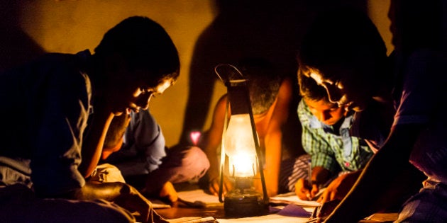 CHOWKIPUR, INDIA, - SEPTEMBER 18: Boys study by lantern light in a house L-R: (children closest to camera) Nitish Suraj (12), Ashish Choudhary (10), Baijunath Paswan (7) in Chowkipur India on September 18, 2015. Chowkipur is a village 60 KM from Patna that has no electricity. (Photo by Simon de Trey-White for the Washington Post)