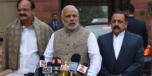 Indian Prime Minister Narendra Modi (C) stands with senior Bharatiya Janata Party (BJP) leaders as he addresses media representatives after arriving for the winter session of Parliament in New Delhi on November 26, 2015. AFP PHOTO/ MONEY SHARMA / AFP / MONEY SHARMA (Photo credit should read MONEY SHARMA/AFP/Getty Images)