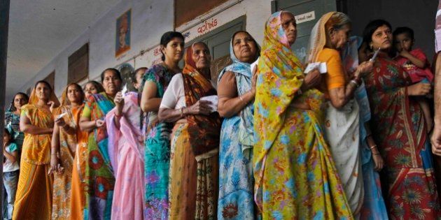 Indian women stand in queue to cast their votes for the second phase of Gujarat state assembly elections in Ahmadabad, India, Monday, Dec. 17, 2012. Ninety-five seats go for polls on Monday in the second and last phase of the elections in which 19.8 million voters will decide the fate of 820 candidates including Chief Minister Narendra Modi, who is seeking his third term, according to local news agency Press Trust of India. (AP Photo/Ajit Solanki)