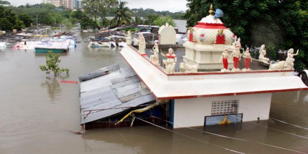 A Hindu temple is partially submerged in flood waters of an over-flowing Adyar River in Chennai, Tamil Nadu, India, Wednesday, Dec. 2, 2015. Weeks of torrential rains have forced the Chennai airport in southern India to close and have cut off several roads and highways, leaving tens of thousands of people stranded in their homes, government officials said Wednesday. (AP Photo)