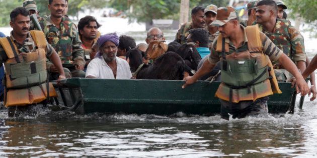 Residents and their goats are rescued by Indian army soldiers from a residential area flooded following heavy rains in Chennai, Tamil Nadu state, India, Tuesday, Nov.17, 2015. Incessant rains that lashed the city since Saturday night flooded several parts of Chennai. (AP Photo/Arun Sankar K)