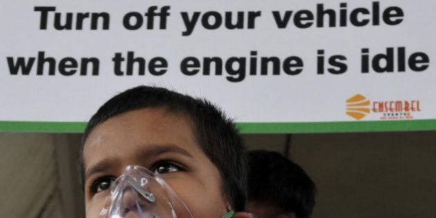 NEW DELHI, INDIA - JUNE 4: School children of Suraj Memorial High School wears an oxygen masks to raise awareness regarding the dangers of air pollution on the eve of World Environment Day at the IIT Red Light crossing on June 4, 2015 in New Delhi, India. The WHO study found New Delhi to have the dirtiest air, with an annual average of 153 micrograms of small particulates, known as PM2.5, per cubic metre.(Photo by Vipin Kumar/Hindustan Times via Getty Images)
