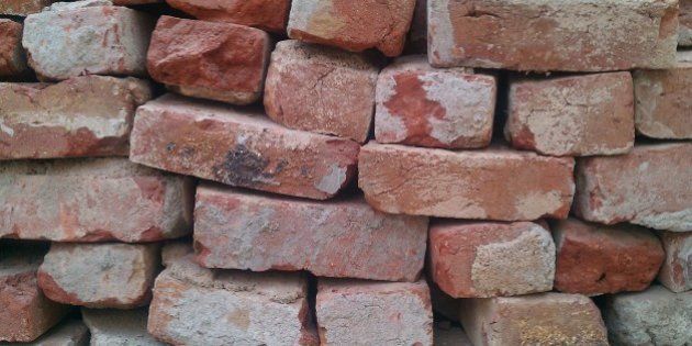 Bricks stored on top of each other, ready to be used for building.