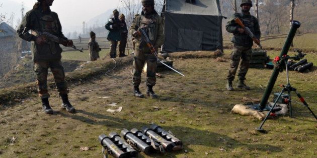 Indian army soldiers prepare to fire mortar shells towards hiding suspected militants in the Maniga area of Kupwara district north of Srinagar on November 23, 2015. A suspected rebel was killed at Maniga, near the frontier town of Kupwara in the north of the Himalayan territory, during an army search of the forested area. AFP PHOTO / AFP / STR (Photo credit should read STR/AFP/Getty Images)