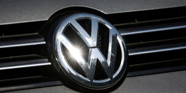 A Volkswagen AG badge sits on a car displayed on the forecourt of a dealership in London, U.K., on Wednesday, Sept. 23, 2015. Volkswagen AG's escalating scandal over emissions-test cheating is beginning to ripple across the $10 trillion global corporate bond market. Photographer: Simon Dawson/Bloomberg via Getty Images