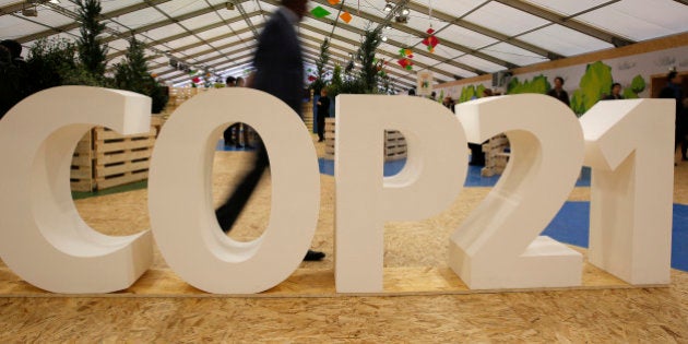 FILE - In this Dec. 1, 2015 file photo, a man visits the Climate Generations Areas, part of the COP21, the United Nations Climate Change Conference, in Le Bourget, north of Paris. As a group, the most religious Americans are less likely than others in the U.S. to trust the science of global warming. Yet a significant number of the faithful not only believe the threat is real but also feel obliged to help save the earthâs climate, an AP analysis shows. (AP Photo/Christophe Ena, File)