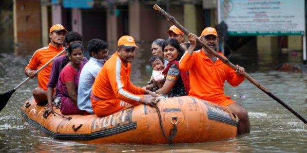 National Disaster Response Force personnel rescue people stranded in floodwaters in Chennai, in the southern Indian state of Tamil Nadu, Friday, Dec. 04, 2015. The relentless rains that lashed southern India's Tamil Nadu state for three days eased Friday, but the misery of tens of thousands of people was far from over, with large parts of the main city still underwater along with the region's biggest airport. (AP Photo/Arun Sankar K)