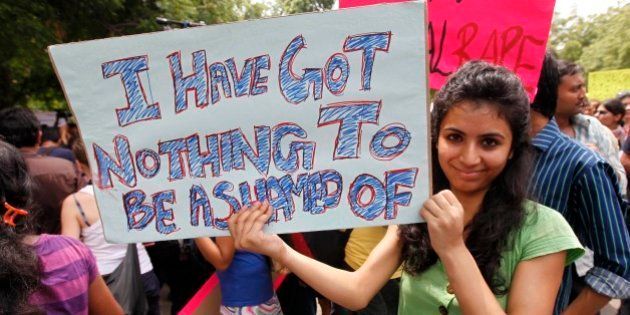 A woman holds a placard at the Delhi