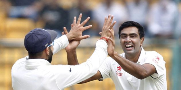 BENGALURU, INDIA - NOVEMBER 14: Indian cricket team player Ravichandran Ashwin and Captain Virat Kohli celebrate the dismissal of South African player Faf du Plessis during the 2nd Test match between India and South Africa at M. Chinnaswamy Stadium on November 14, 2015 in Bengaluru, India. (Photo by Ajay Aggarwal/Hindustan Times via Getty Images)