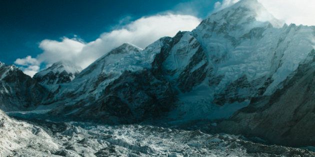 MOUNT EVEREST, NEPAL, FEBRUARY 13, 2015: THe Khumbu Glacier is seen after fresh snowfall near the base of Mount Everest (C, 8848m) and Nuptse (R, 7861m) in the Solu-Khumbu region of Nepal, February 13, 2015. The Solu-Khumbu region is home to the world's highest mountain, Mount Everest (8848m). According to leading researchers, in recent years the landscape and people of the Solu-Khumbu region have come under increasing pressure from raising temperatures and shifting climactic conditions. As well as being home to many of the world's highest mountains, the region holds some of the world's largest and highest glaciers, some of which have begun to show signs of increased and rapid melt. The Khumbu glacier, which lies at the foot of Mount Everest, has in the last decade begun to develop ponds of water on its surface, which scientists say could develop into a much larger lake on the glacierÃ¢s surface if warming trends continue. Recent research indicates that annual mean surface temperature in the Himalaya has increased by 1.5 degrees celsius over pre-industrial temperatures. (Photo by Ed Giles/Getty Images).