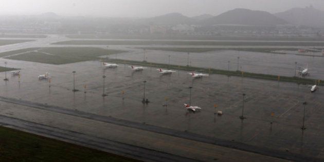 Aircrafts are seen parked in the waterlogged airport after heavy rainfall in Chennai, India, Saturday, Dec. 5, 2015. Although floodwaters have begun to recede, vast swaths of Chennai and neighboring districts were still under 2 1/2 to 3 meters (8 to 10 feet) of water, with tens of thousands of people in state-run relief camps. (AP Photo/Arun Sankar K)
