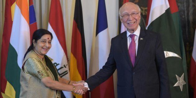Pakistan's National Security Advisor Sartaj Aziz (R) shakes hands with Indian Foreign Minister Sushma Swaraj at The Foreign Ministry in Islamabad on December 9, 2015, ahead of talks. Afghan president Ashraf Ghani arrived in Islamabad hoping to revive peace talks with the resurgent Taliban, as he opened a regional conference that has taken on added significance with the attendance of India's top diplomat. AFP PHOTO / Aamir QURESHI / AFP / AAMIR QURESHI (Photo credit should read AAMIR QURESHI/AFP/Getty Images)