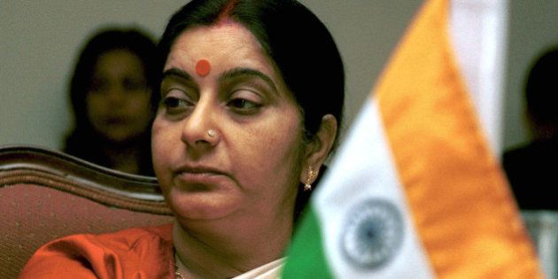 India's Broadcast Minister Sushma Swaraj sits behind an Indian flag as she attends a session of the Information Ministers Conference of South Asian Association for Regional Cooperation (SAARC) in Islamabad, Pakistan, on Friday, March 8, 2002. (AP Photo/Tariq Aziz)