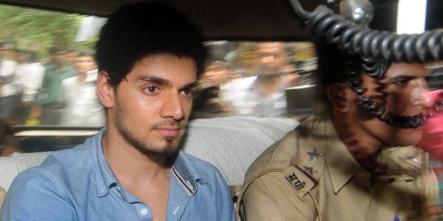 Indian actor Suraj Pancholi, boyfriend of the late Bollywood film actress Jiah Khan, sits inside a police vehicle on his way to a court in Mumbai on June 11, 2013, on suspicion of abetting her suicide after her family found a letter in her room. Suraj Pancholi, a 22-year-old aspiring actor, was detained on June 10 a week after his girlfriend's body was discovered by her parents at her home. AFP PHOTO (Photo credit should read STR/AFP/Getty Images)