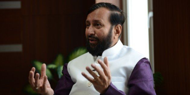 To go with 'Climate-Warming-UN-COP21-India' by Annie BanerjiIn this photograph taken on November 19, 2015, India's Minister of Environment, Forests and Climate Change Prakash Javadekar gestures as he speaks during an interview with AFP at Indira Paryavaran Bhawan in New Delhi. India will urge rich nations to deliver 'climate justice' for developing countries at a major environmental conference in Paris later this month, the environment minister has said in an interview with AFP. Prakash Javadekar called on industrialised countries to commit to more stringent targets to free up 'carbon space' for the developing world to generate emissions as a necessary byproduct of growth. AFP PHOTO/Money SHARMA (Photo credit should read MONEY SHARMA/AFP/Getty Images)