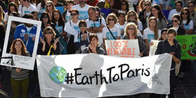 Environmental activists and supporters during a rally calling for action on climate change in Los Angeles, California on November 29, 2015, a day before the start of the COP21 conference in Paris. Some 150 leaders, including US President Barack Obama, China's Xi Jinping, India's Narendra Modi and Russian President Vladimir Putin, will attend the start of the Paris conference, which is tasked with reaching the first truly universal climate pact, with the goal to limit average global warming to two degrees Celsius (3.6 degrees Fahrenheit), perhaps less, over pre-Industrial Revolution levels by curbing fossil fuel emissions blamed for climate change. AFP PHOTO/ MARK RALSTON / AFP / MARK RALSTON (Photo credit should read MARK RALSTON/AFP/Getty Images)