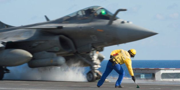 CAPTION CORRECTS THE SLUG - This photo released on Monday, Nov. 23, 2015 by the French Army Communications Audiovisual office (ECPAD) shows a French army Rafale fighter jet taking off from the deck of France's aircraft carrier Charles De Gaulle, in the Mediterranean sea. The French Defense Ministry says it has launched its first airstrikes from the aircraft carrier Charles de Gaulle, bombing Islamic State targets in the Iraqi cities of Ramadi and Mosul. (Defense Ministry/ECPAD via AP) THIS IMAGE MAY ONLY BE USED FOR 30 DAYS FROM TIME TRANSMISSION.