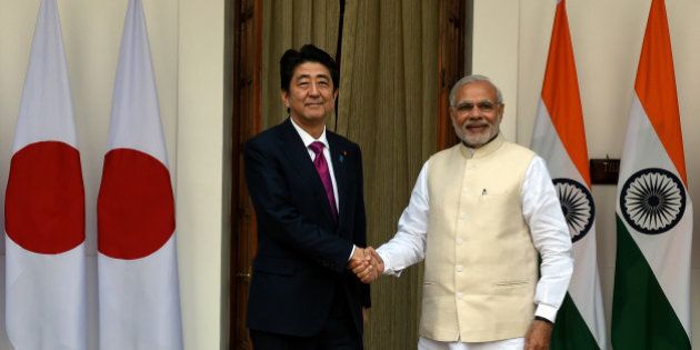 India's Prime Minister Narendra Modi (R) shakes hands with Japan's Prime Minister Shinzo Abe before a meeting at Hyderabad House in New Delhi on December 12, 2015. Indian Prime Minister Narendra Modi and his Japanese counterpart Shinzo Abe are expected to discuss deals covering high-speed rail, defence and civilian nuclear technology when they hold talks. AFP PHOTO / Money SHARMA / AFP / MONEY SHARMA (Photo credit should read MONEY SHARMA/AFP/Getty Images)