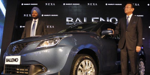 NEW DELHI, INDIA - OCTOBER 26: Managing Director and CEO of Maruti Suzuki, Kenichi Ayukawa along with RS Kalsi (Executive Director, Marketing & Sales) poses with the new Maruti Suzuki, Baleno car, during its launch on October 26, 2015 in New Delhi, India. Maruti Suzuki India will for the first time export a made-in-India car to Japan, the home of parent Suzuki Motor Corp. in a move that could lead to India becoming a Suzuki export hub. The company will begin exporting it to 100 countries including Japan and Europe from early 2016 as it works to establish itself alongside more upmarket global automakers. (Photo by Virendra Singh Gosain/Hindustan Times via Getty Images)