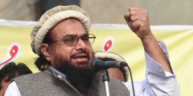 Pakistani leader of the Jamat ud-Dawa organisation Hafiz Saeed addresses a rally against the printing of satirical sketches of the Prophet Mohammed by French magazine Charlie Hebdo in Lahore on January 23, 2015. Thousands of people marched in Pakistan January 23 against French satirical magazine Charlie Hebdo as anger remains high in the Muslim majority country over the publication of cartoons of the Prophet Mohammed. AFP PHOTO / Arif ALI (Photo credit should read Arif Ali/AFP/Getty Images)