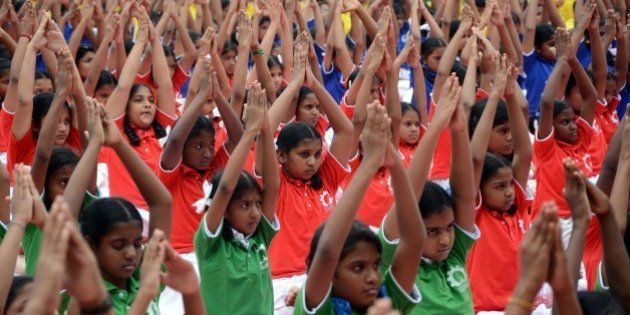 Indian schoolchildren take part in a yoga programme in Chennai on June 19, 2015, ahead of International Yoga Day on June 21. Preparations in India have been gathering pace since the UN agreed to the day, with schools, military barracks and even jails encouraged to participate in their own sessions. AFP PHOTO/STR (Photo credit should read STRDEL/AFP/Getty Images)