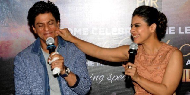 Indian Bollywood actors Shah Rukh Khan (L) and Kajol Devgn appear at a promotional event for their upcoming Hindi film 'Dilwale' in Mumbai on December 11, 2015. AFP PHOTO / AFP / STR (Photo credit should read STR/AFP/Getty Images)